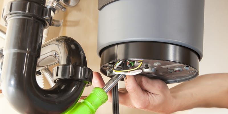 Technician repairing the heating element of a water heater in Lynn Haven