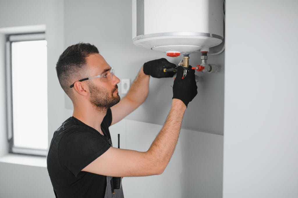 Technician performing water heater maintenance in Lynn Haven