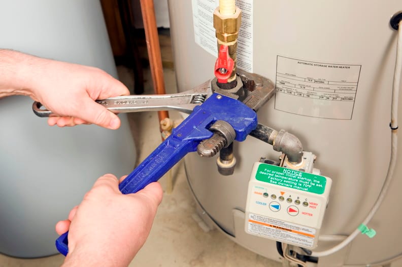 Plumber repairing a water heater valve in Lynn Haven